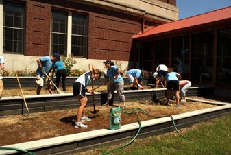 The hard working mentality of AthletiCo's employees is on display as dozens work on a landscaping project.