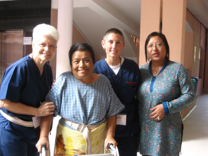 Volunteers pose for a picture with a patient after a rehabilitation session.