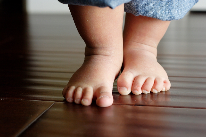 infant walking on tiptoes